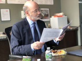 Gov. Wolf looks over a report on progress